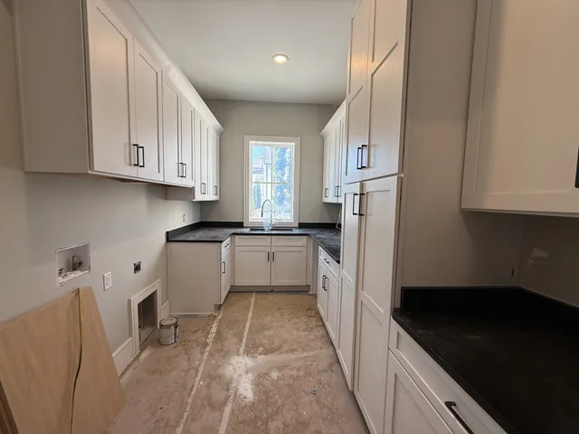 a view of a hallway with cabinet and a mirror