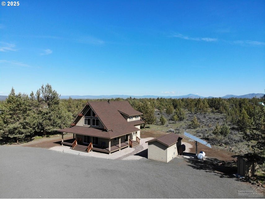5215 Southwest Upper Canyon Rim Drive Culver, OR 97734 - Photo 2 of 24 an aerial view of a house with a garden and mountain view