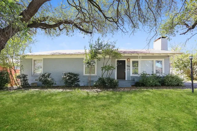 a front view of house with yard and green space