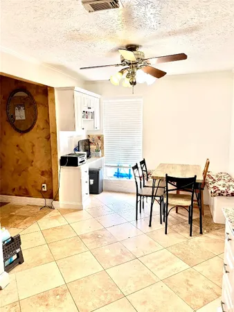 a view of a patio with dining table and chairs