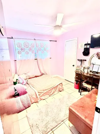 a bedroom with a bed and a dresser with the shoe rack