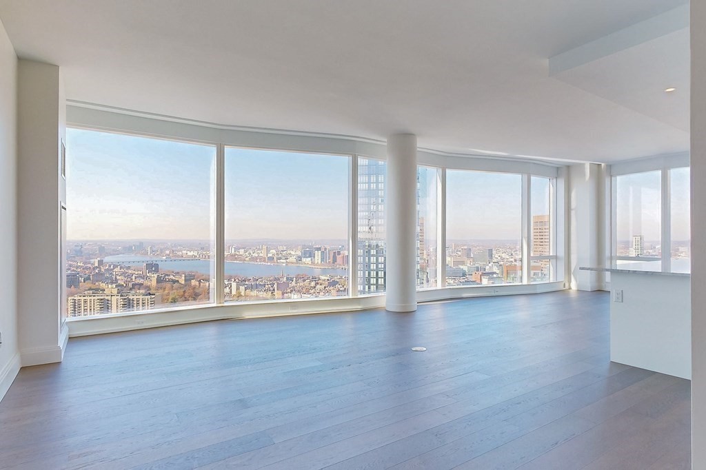 240 Devonshire Street, Unit 3901 Boston, MA 02110 - Photo 4 of 40 a view of an empty room with wooden floor and a window