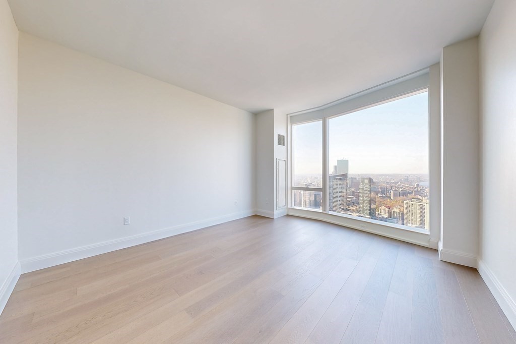 240 Devonshire Street, Unit 3901 Boston, MA 02110 - Photo 7 of 40 an empty room with wooden floor and windows