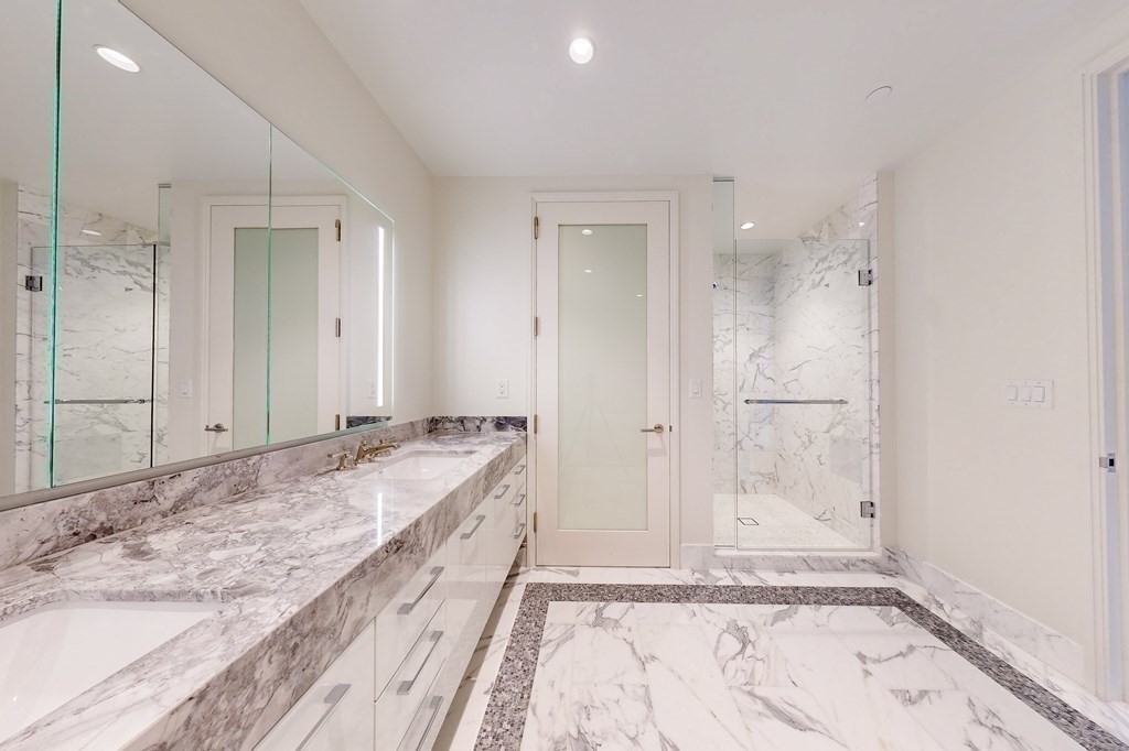 240 Devonshire Street, Unit 3901 Boston, MA 02110 - Photo 8 of 40 a spacious bathroom with a granite countertop sink and a mirror