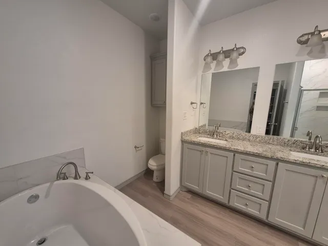 a bathroom with a double vanity sink and mirror