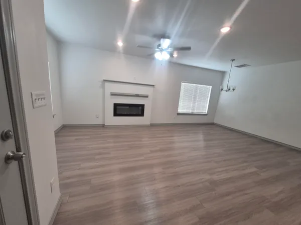wooden floor in an empty room with a mirror
