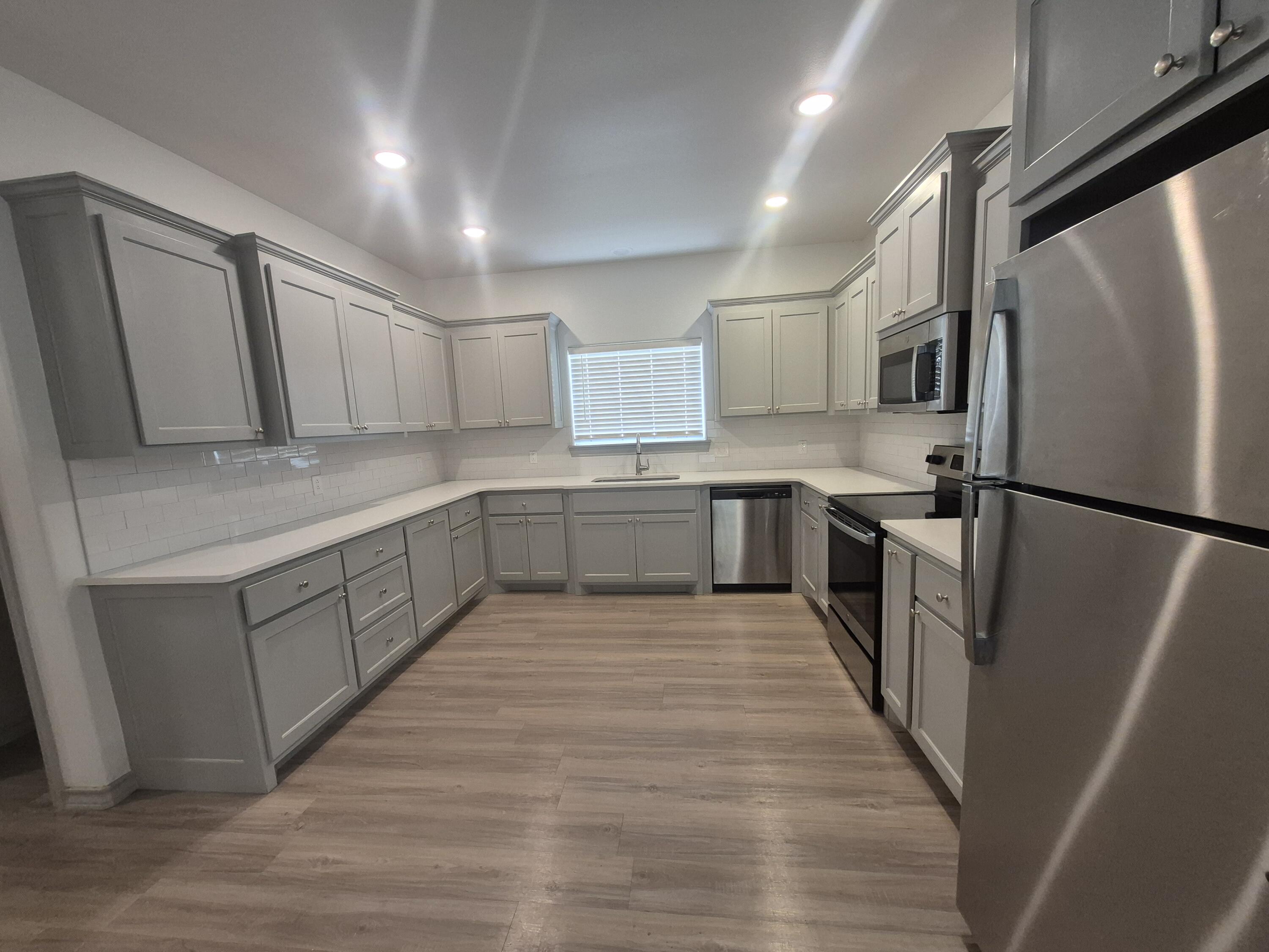 4718 125th Street Lubbock, TX 79424 - Photo 6 of 18 a kitchen with stainless steel appliances granite countertop a refrigerator a sink dishwasher and a stove