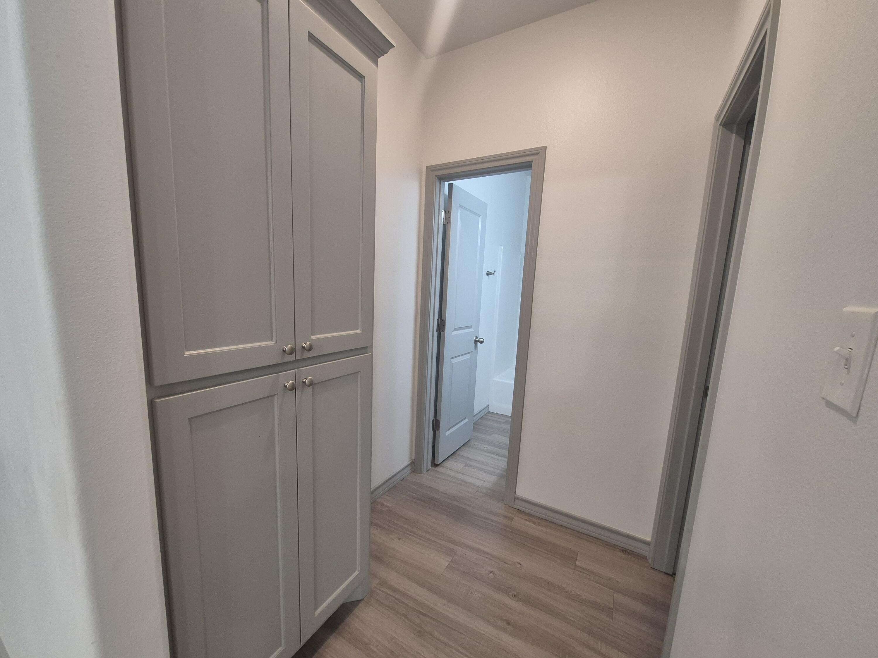 4718 125th Street Lubbock, TX 79424 - Photo 7 of 18 a view of a hallway with wooden floor