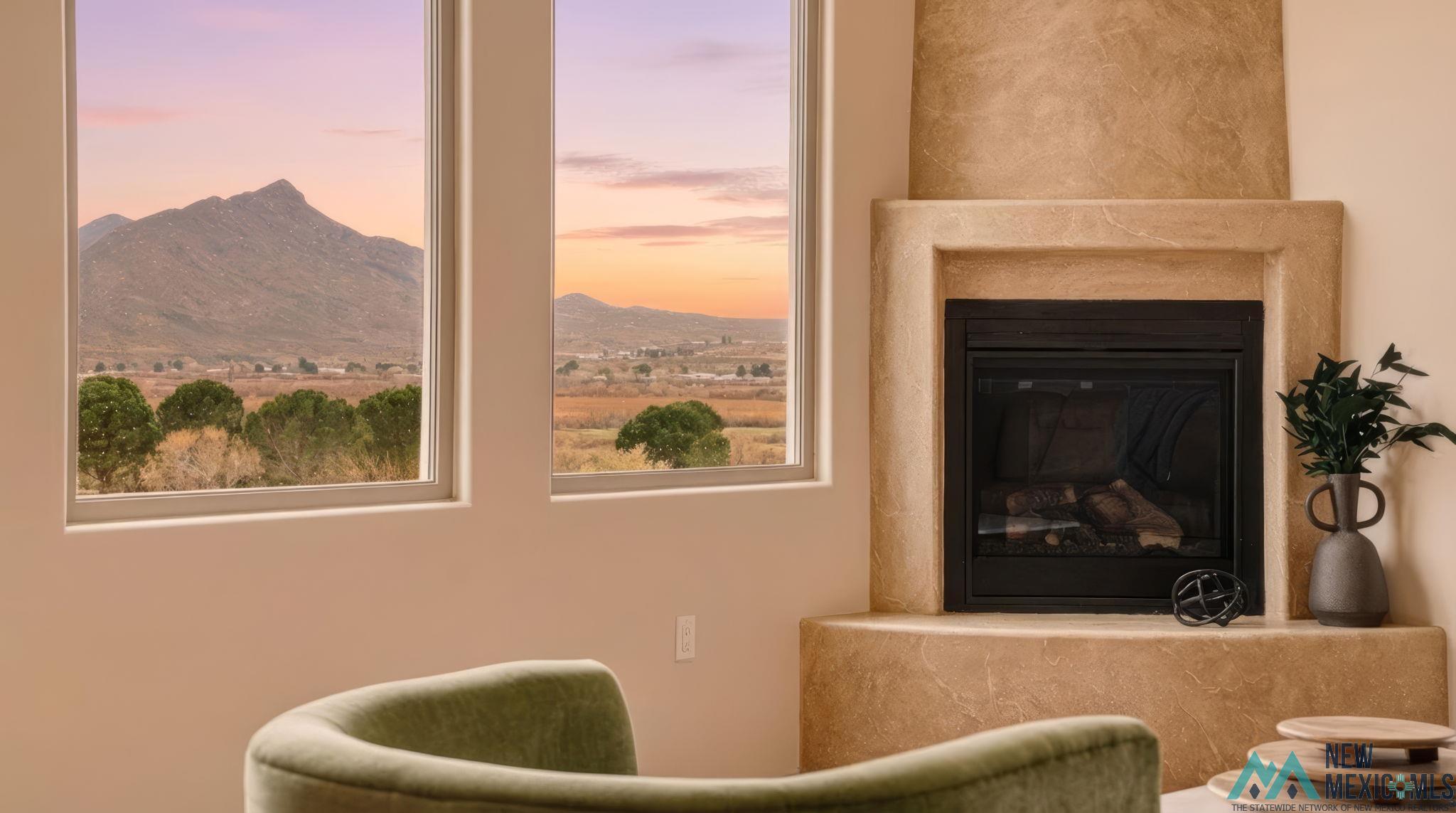 119 Mesa Grande Road Elephant Butte, NM 87935 - Photo 4 of 34 Detailed view of a mountain backdrop and a glass covered fireplace