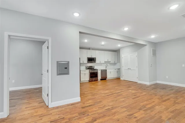 a view of kitchen with kitchen island granite countertop a stove and a refrigerator