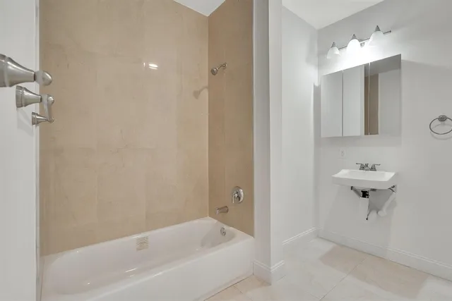 a bathroom with a bathtub and shower