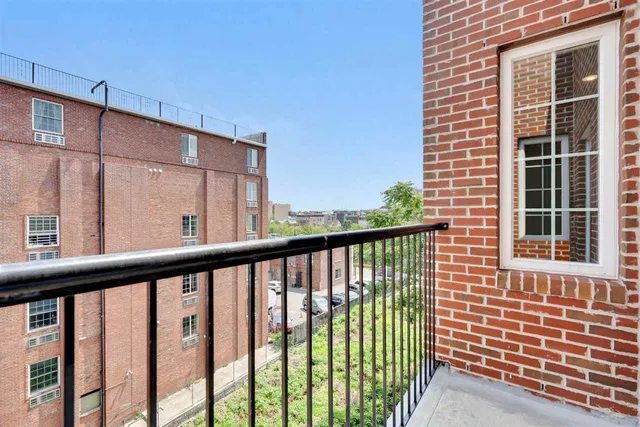 a view of a balcony with a floor to ceiling window
