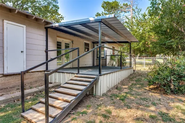 a backyard of a house with garden and deck