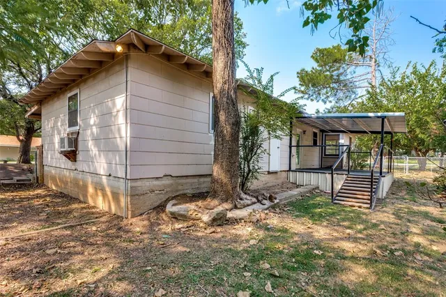a view of a backyard with a tree