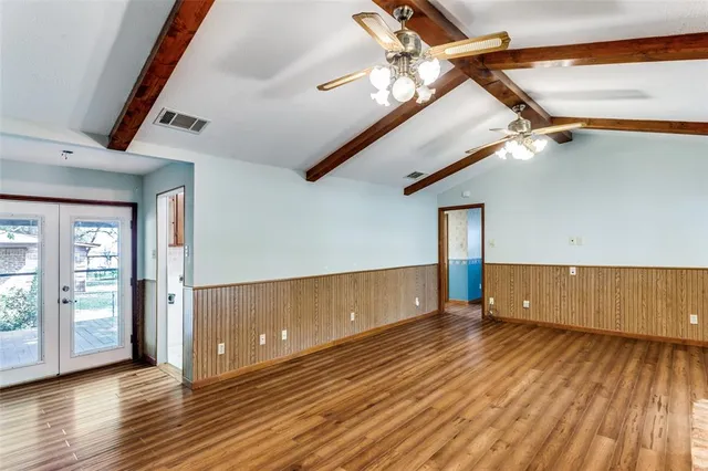 a view of a room with wooden floor