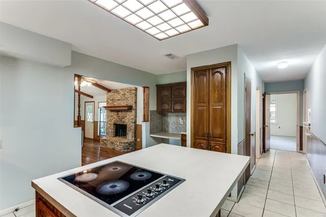 a view of a hallway with a flat screen tv and a fireplace
