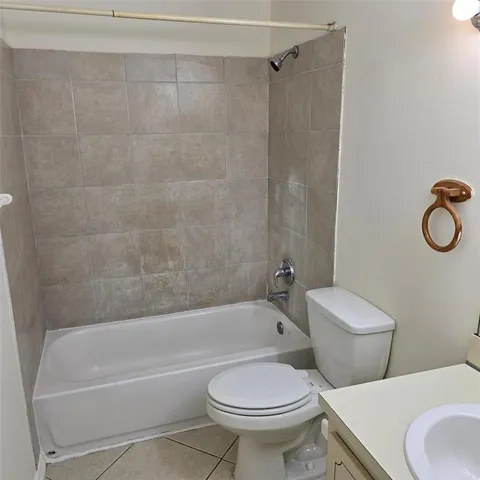 a white toilet and a bath tub sitting next to a shower