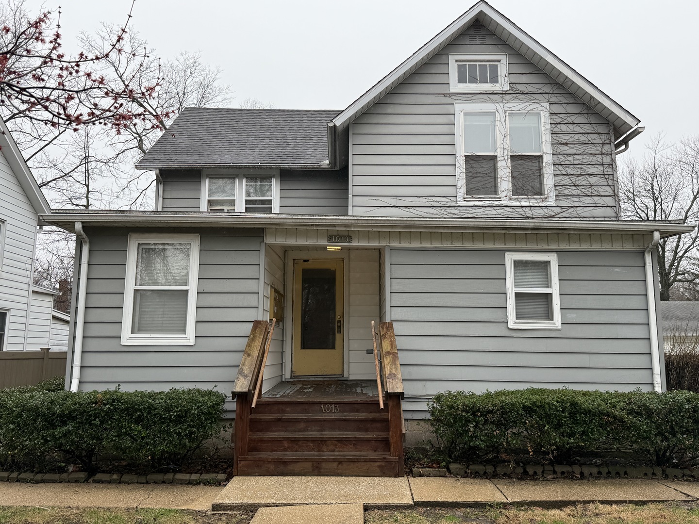 1013 West Church Street Champaign, IL 61821 - Photo 3 of 14 a front view of a house with a yard