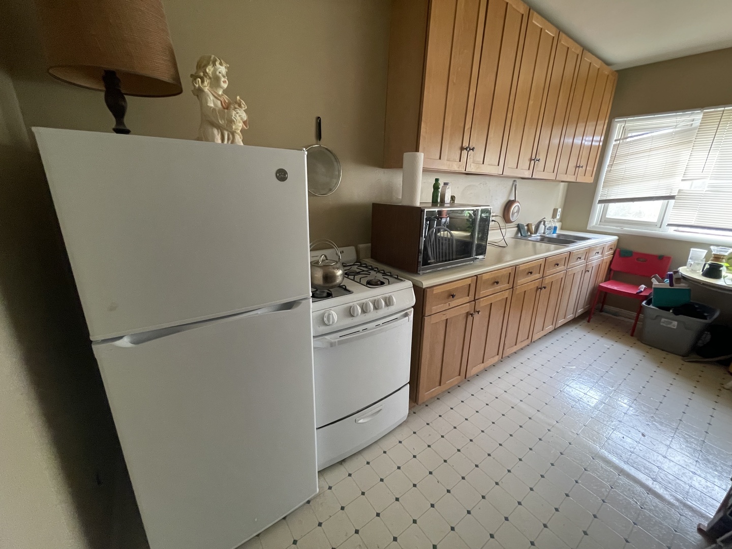 1013 West Church Street Champaign, IL 61821 - Photo 7 of 14 a kitchen with a sink appliances cabinets and a window