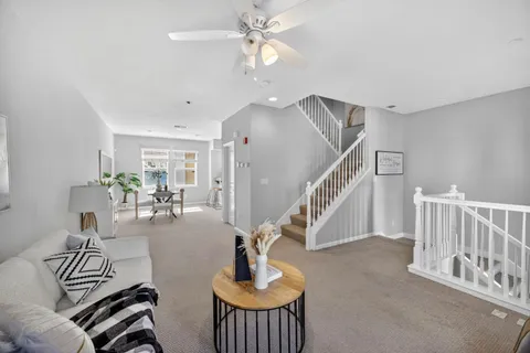 a living room with furniture and a chandelier