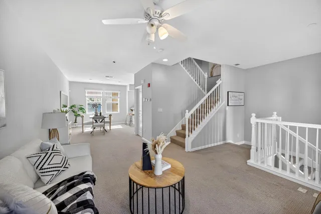 a living room with furniture and a chandelier