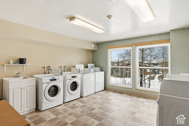 150 Ridgeview Street Brian Head, UT 84719 - Photo 25 of 43 Laundry area with tiled flooring, multiple washing machines and dryers, double windows, and a utility sink