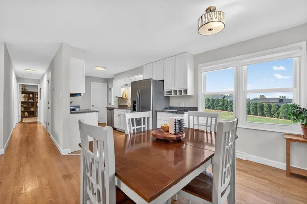 a living room with furniture a table and wooden floor