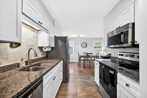 a kitchen with stainless steel appliances a refrigerator sink and cabinets
