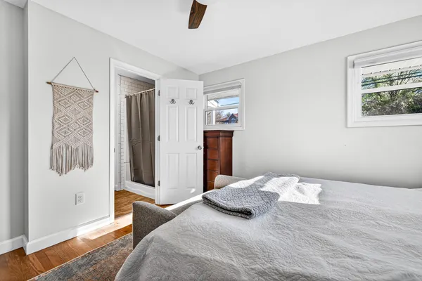 a bedroom with a bed and a mirror on dresser