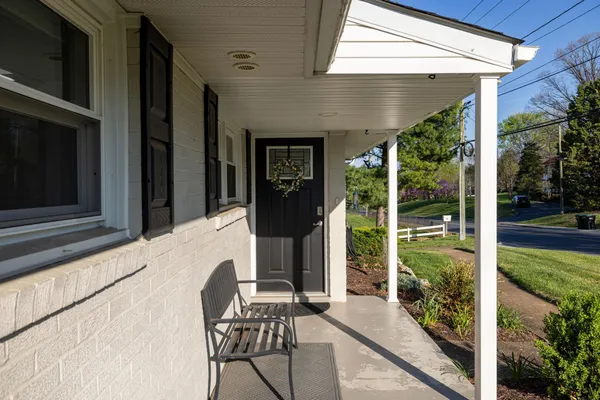 a view of a porch with furniture and garden