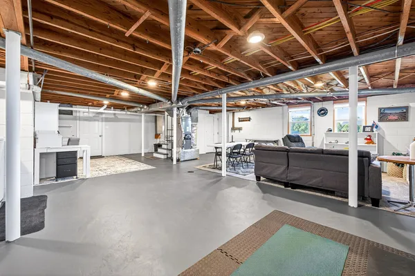 an aerial view of a residential houses with outdoor space and trees all around