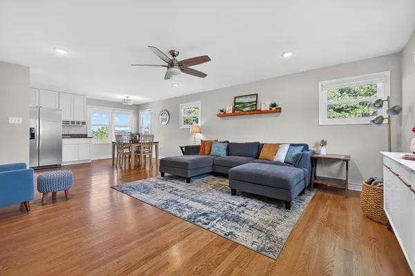 a living room with furniture and a wooden floor