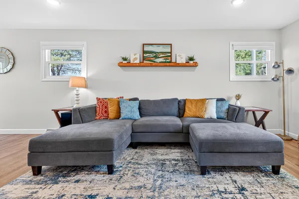 a living room with a couch and painting on the wall