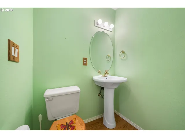 a bathroom with a sink toilet and a mirror