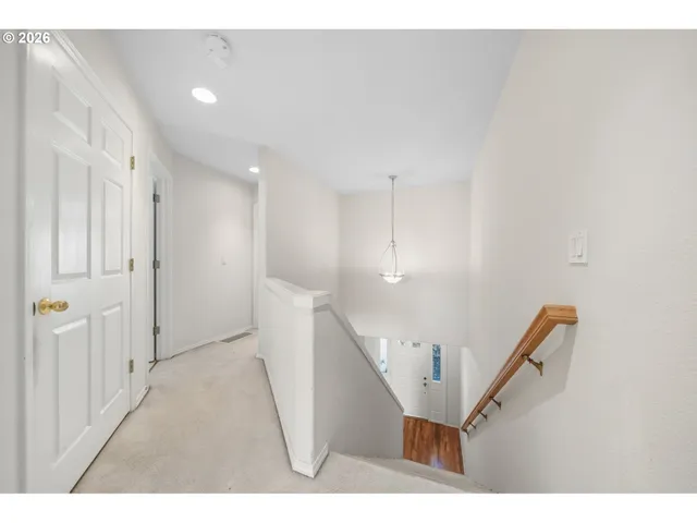 a view of a hallway with stairs