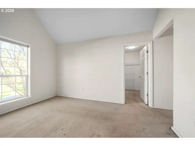 an empty room with windows and closet