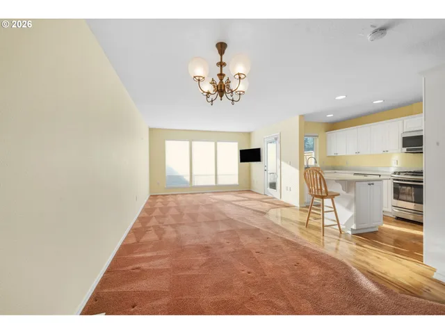 a view of a kitchen with a sink and a refrigerator