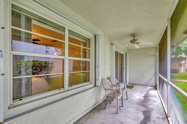 a view of a balcony with chair and table