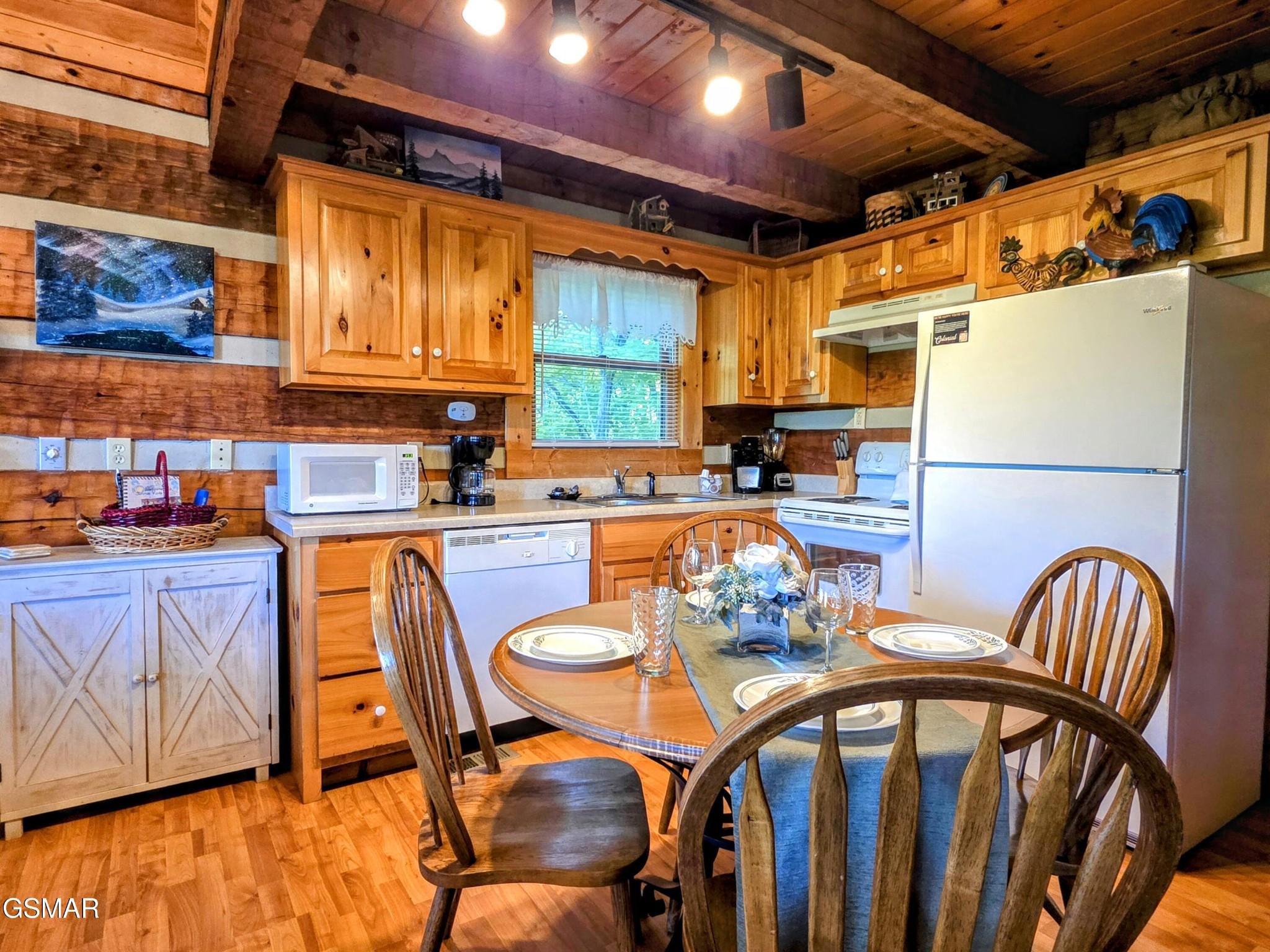 2570 Pittman Center Road Sevierville, TN 37876 - Photo 44 of 61 a dining room with stainless steel appliances a dining table and chairs