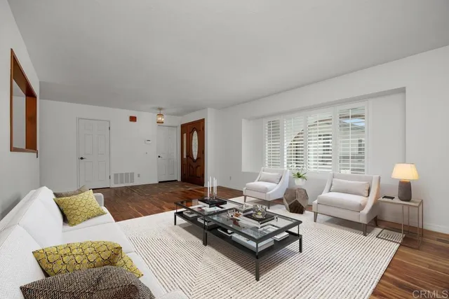 a living room with furniture rug and window