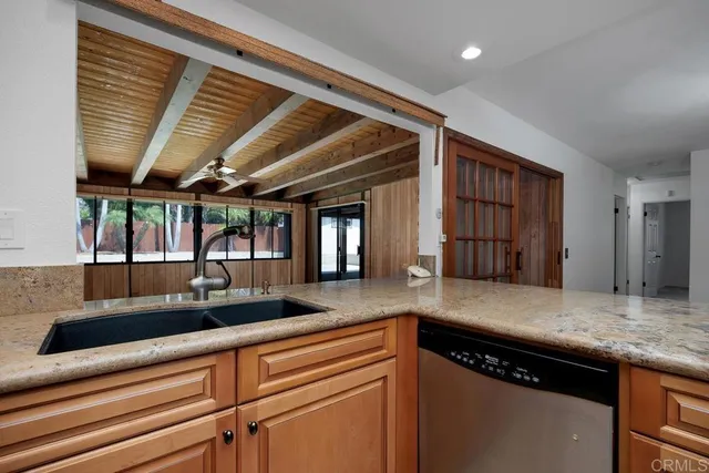 a kitchen with granite countertop a sink and a counter top space