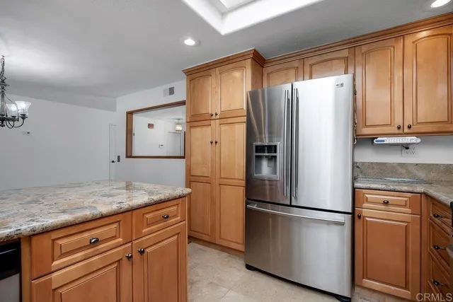 a kitchen with stainless steel appliances granite countertop a refrigerator sink and cabinets