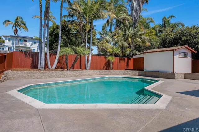 a front view of house with yard and swimming pool