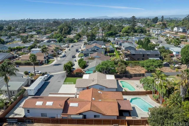 an aerial view of residential houses with outdoor space