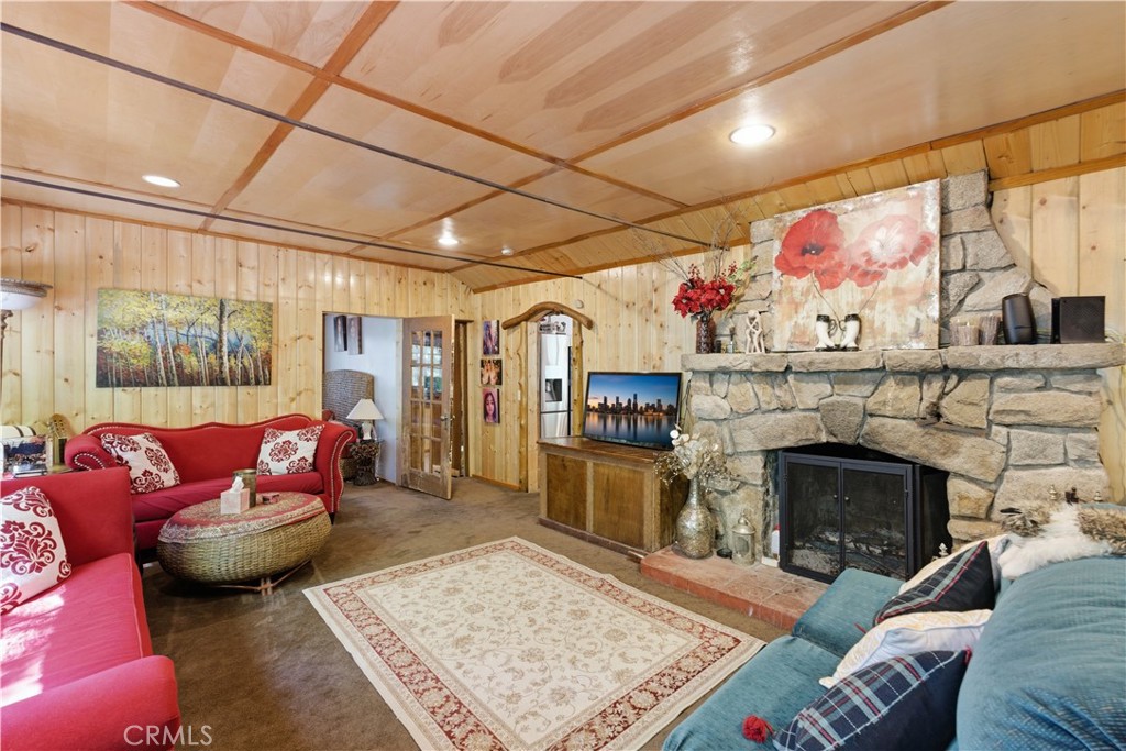 815 Cottage Grove Road Lake Arrowhead, CA 92352 - Photo 12 of 46 a living room with furniture a flat screen tv and a fireplace