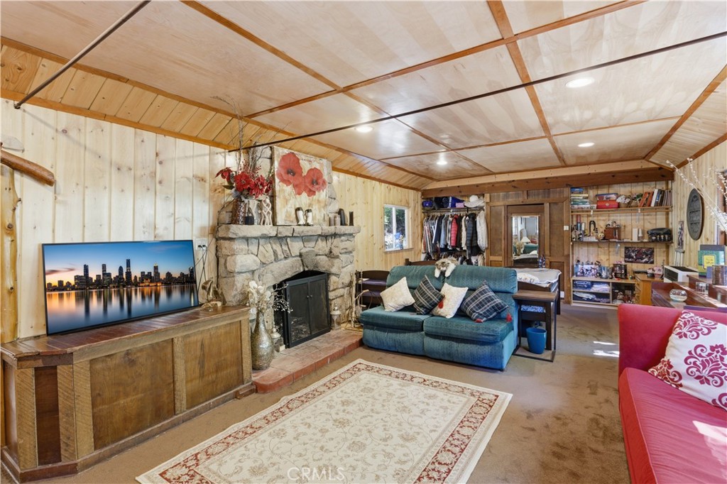 815 Cottage Grove Road Lake Arrowhead, CA 92352 - Photo 13 of 46 a living room with furniture and a fireplace