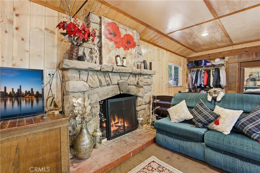 815 Cottage Grove Road Lake Arrowhead, CA 92352 - Photo 16 of 46 a living room with furniture and a fireplace