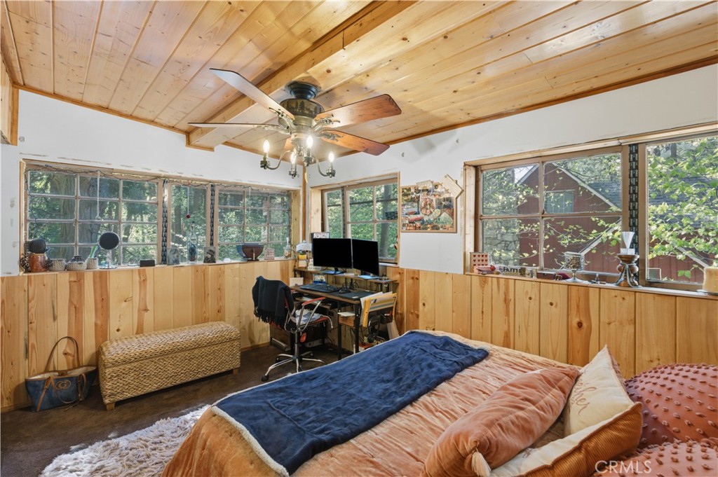 815 Cottage Grove Road Lake Arrowhead, CA 92352 - Photo 29 of 46 a bedroom with a bed a large window with table and chairs