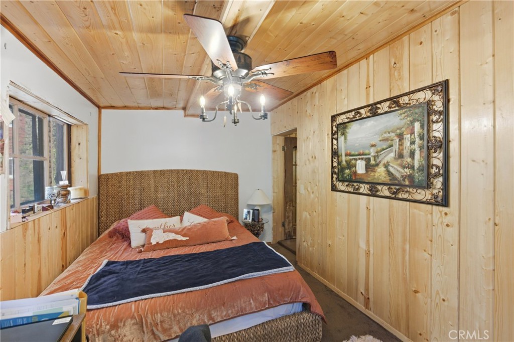 815 Cottage Grove Road Lake Arrowhead, CA 92352 - Photo 30 of 46 a bedroom with a bed and a painting on the wall