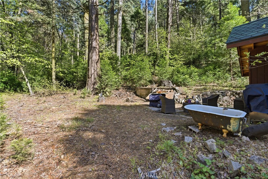 815 Cottage Grove Road Lake Arrowhead, CA 92352 - Photo 38 of 46 a backyard of a house with outdoor seating